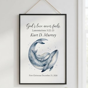 May include: A framed wall print featuring a watercolour illustration of two blue whales, one large and one small, surrounded by bubbles. The text reads God's love never fails. Lamentations 3:22-23, the name Kurt D. Murray, and First Christmas December 25, 2026.