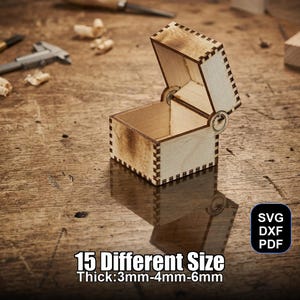 Puede incluir: Una pequeña caja de madera abierta con tapa con bisagras, que muestra un diseño cortado con láser. La caja es de color claro con bordes más oscuros y un reflejo visible. El texto en la imagen dice "15 Different Size Thick: 3mm-4mm-6mm".