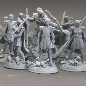 May include: A collection of unpainted gray resin miniature figurines depicting elf-like warriors in detailed armor, capes, and tunics. Each figure stands on a circular base decorated with small mushroom-like growths, holding various weapons including swords and bows.