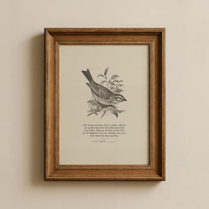 May include: A framed print with a detailed monochrome illustration of a bird on a branch. The print includes text from Matthew 10:29-31. The frame is a warm brown colour, providing a classic aesthetic to the artwork.