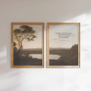 May include: Two framed landscape prints. One features a tree and a body of water. The other print has a similar landscape with text that reads "The steadfast love of the Lord never ceases; his mercies never come to an end; they are new every morning; great is your faithfulness."