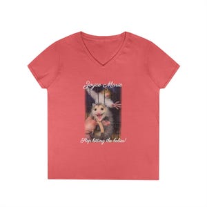 May include: Coral V-neck t-shirt with a graphic of an opossum holding a stick, and the text "Joyce Marie" and "Stop hitting the babies!".
