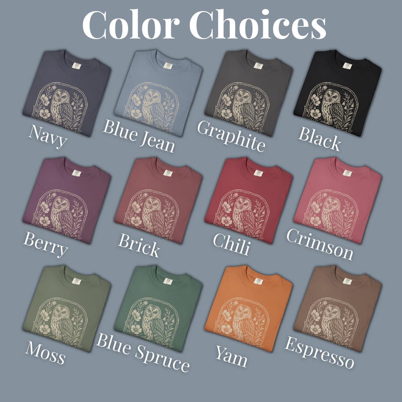 A selection of crew neck t-shirts in various colors, including navy, blue jean, graphite, and black. Each shirt features a beige owl graphic within a floral frame. The text "Color Choices" is at the top, with color names below each shirt.