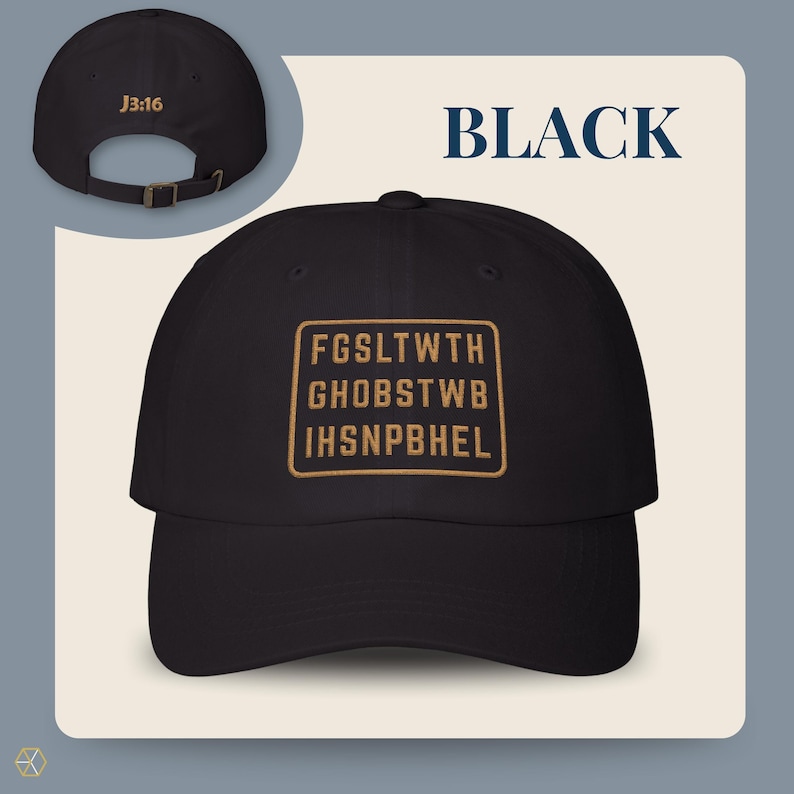 Black baseball cap with the text "BLACK" and "J3:16". The front of the cap features a gold rectangular design with the text "FGSLTWTH GHOBSTWBI HSNPBHEL". The cap has an adjustable strap.