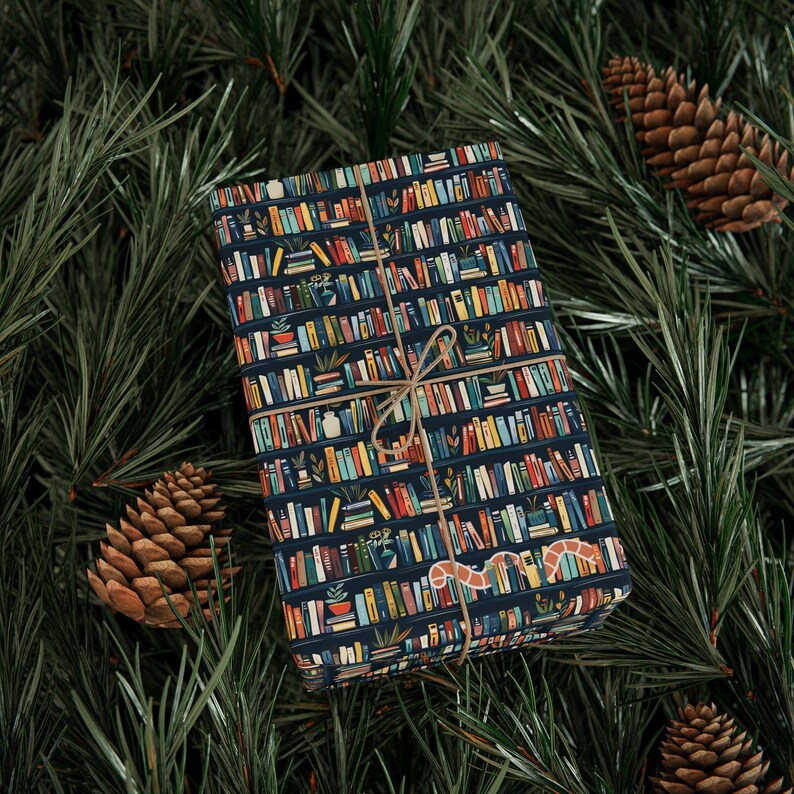 Premium wrapping paper with tiny books on a shelf wrapping a small parcel and tied with twine.