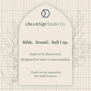 The image is a graphic design featuring a text box with a floral pattern and a geometric shape above it. The text box contains a message about a business called "Bible. Brontë. Ball Cap." and expresses gratitude for supporting the business.