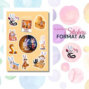 May include: A sheet of A5 format stickers featuring cartoon bunnies in various scenes, including Egyptian-themed illustrations. The stickers are in a variety of poses and settings, with a color palette of yellow, white, and black.
