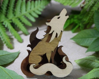 May include: Wooden cutout of a wolf howling at the moon, with a stylised flame design behind it. The wolf is painted in shades of brown and white.