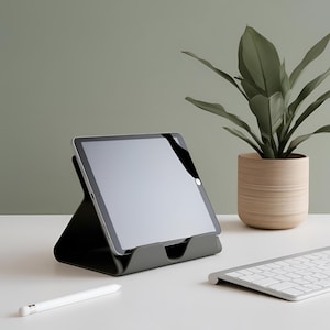 May include: A white ceramic mug with a black handle and the text "But First, Coffee" in a black, bold font. The mug is sitting on a wooden surface. The mug is approximately 4 inches tall.