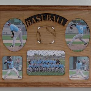 May include: A wooden picture frame with a baseball theme. The frame has five photo openings, one with a baseball, two with individual players, one with a team photo, and one with a player batting. The frame is made of light brown wood and has the word "BASEBALL" carved into the top.