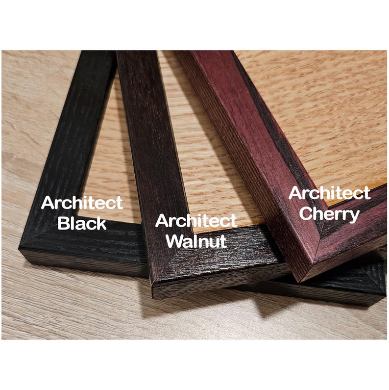 May include: Three wooden picture frames with mitered corners, labeled Architect Black, Architect Walnut, and Architect Cherry. Each frame features a distinct wood grain texture and color, ranging from deep black to dark brown and reddish-brown tones.