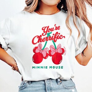 Retro cherry graphic t-shirt featuring a playful fruit design suitable for kids, teens, and adults. Comfortable unisex summer tee perfect for vacations, casual outings, summer activities, and everyday wear. Lightweight and soft fabric with fun, colorful cherry artwork. Ideal for gifting, playful summer wardrobe additions, or matching family outfits. Stylish and versatile graphic shirt for retro-inspired and casual summer fashion.
