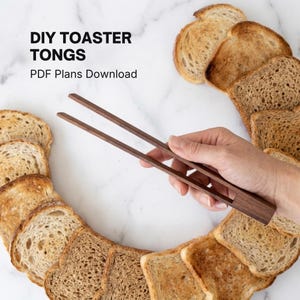 May include: Wooden toaster tongs held over a circle of toasted bread slices. The tongs are dark brown and have a simple, functional design. Text on the image reads "DIY TOASTER TONGS PDF Plans Download."