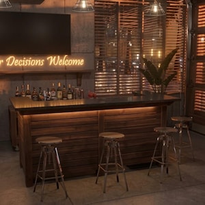 May include: A wooden bar with a dark countertop and a selection of bottles. The bar is illuminated by under-counter lighting, creating a warm atmosphere. Three metal stools are positioned in front. A neon sign above the bar reads "Your Decisions Welcome."