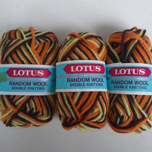 May include: Three skeins of Lotus Random Wool Double Knitting yarn. Each skein is a mix of brown, orange, and light green. The yarn is wrapped with a blue label that has the Lotus logo in red.