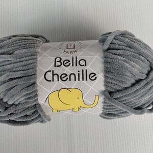 May include: A skein of gray chenille yarn with a label that reads "Universal Yarn Bella Chenille" and features a cartoon elephant.