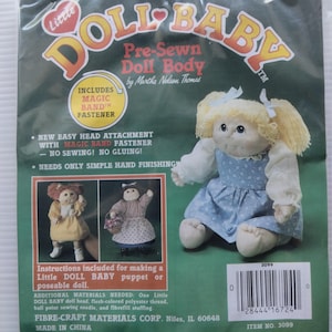 May include: A package for a Little Doll Baby pre-sewn doll body kit. The package includes instructions for making a puppet or poseable doll. The doll body is made of white fabric and has a blue dress. The package includes a Magic Band fastener. The package is from Fibre-Craft Materials Corp. Niles, IL 60648. Made in China. Item No. 3099.