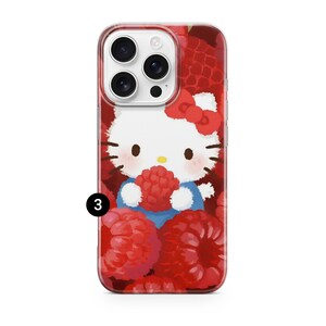May include: Clear phone case featuring a cartoon illustration of Hello Kitty holding a raspberry, set against a background of red raspberries. The case has a clear border and a camera cutout.