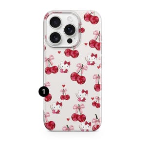 May include: A white phone case featuring a pattern of red cherries, pink bows, and small red hearts. The design also includes a cartoon character with a red bow. The case has a clear camera cutout.