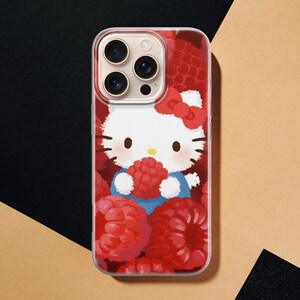 May include: A clear phone case featuring a cartoon image of Hello Kitty holding a raspberry. The design includes a red bow, blue clothing, and a background of red raspberries. The phone case is designed to fit a smartphone.