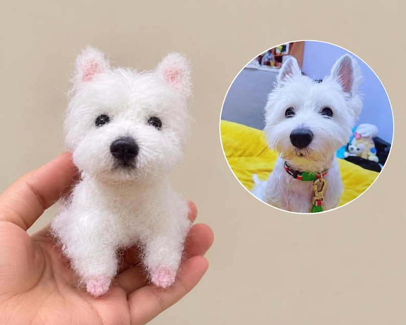 May include: A small, white, fuzzy, crocheted West Highland White Terrier figurine with black eyes and a black nose. Beside it is a circular inset photograph of a real white dog wearing a colourful collar, matching the appearance of the figurine.