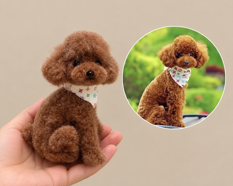 May include: A small, brown, curly-haired toy poodle figurine with a white bandana featuring a colourful, repeating geometric pattern. The figurine is shown in a circular inset image alongside a real dog wearing the same bandana.