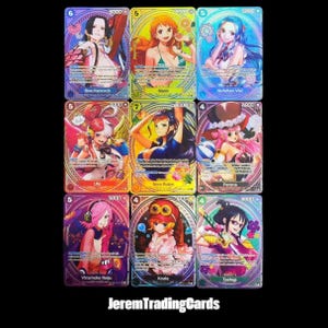May include: A collection of nine One Piece trading cards arranged in a grid, featuring colourful anime-style illustrations of characters including Boa Hancock, Nami, Nefeltari Vivi, Uta, Nico Robin, Perona, Vinsmoke Reiju, Koala, and Tashigi.