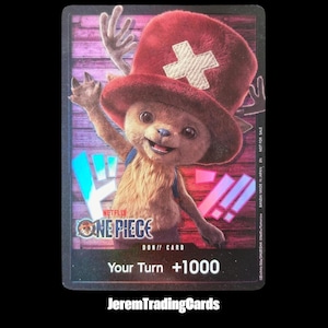 May include: A rectangular trading card featuring a furry, brown, anthropomorphic character wearing a large red hat with a white cross emblem. The card displays the text ONE PIECE, DON!! CARD, and Your Turn +1000 against a purple wood-plank background.