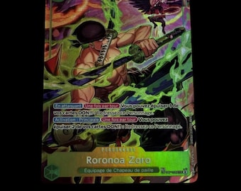 May include: A One Piece trading card featuring Roronoa Zoro with a power level of 9000. The card displays a green and purple color scheme with dynamic green energy effects, Japanese text, and French game instructions printed on the front surface.
