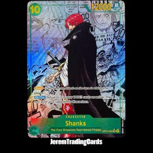 Puede incluir: Una carta coleccionable de One Piece que muestra al personaje Shanks con cabello rojo y una capa negra. La carta tiene un nivel de poder de 12000, un coste de 10 e incluye texto que detalla las habilidades Rush y On Play sobre un fondo manga.