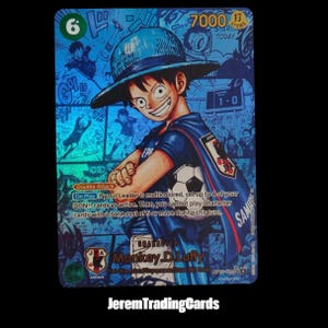 May include: A holographic trading card featuring Monkey D. Luffy wearing a straw hat and a blue jersey, holding a football. The card displays the text 7000, Double Attack, On Play, and Character Monkey D. Luffy, set against a blue manga-style background.