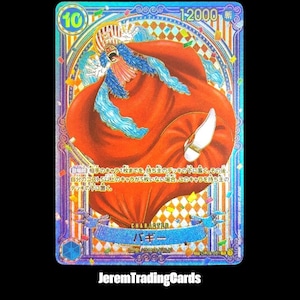 Peut inclure: Carte de collection holographique avec le personnage Buggy de One Piece. La carte présente un design vibrant avec une cape rouge, des cheveux bleus et une couronne dorée. La carte contient également du texte japonais et le chiffre 10.