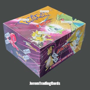 May include: A sealed Pokemon Neo Destiny trading card game booster box featuring colorful illustrations of various creatures including Celebi, Ampharos, and Jolteon. The box displays the Pokemon logo, the Neo Destiny title, and multiple Wizards of the Coast logos.