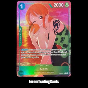 May include: A holographic One Piece trading card featuring Nami with orange hair, holding an orange against a sunset background. The card displays the text Nami, 2000 power, and game instructions. It includes a green and blue border design.