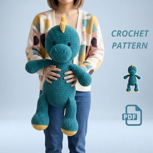 May include: A teal crochet dinosaur plush toy with a yellow dorsal fin and yellow feet. The text CROCHET PATTERN is visible alongside a smaller graphic of the dinosaur and a PDF icon. The toy features a rounded head, dark eyes, and limbs.
