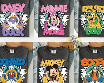 May include: A collection of six charcoal gray t-shirts featuring graphic prints of Disney characters including Daisy Duck, Minnie Mouse, Pluto, Donald Duck, Mickey Mouse, and Goofy. Each shirt displays the character name in bold, colorful lettering.