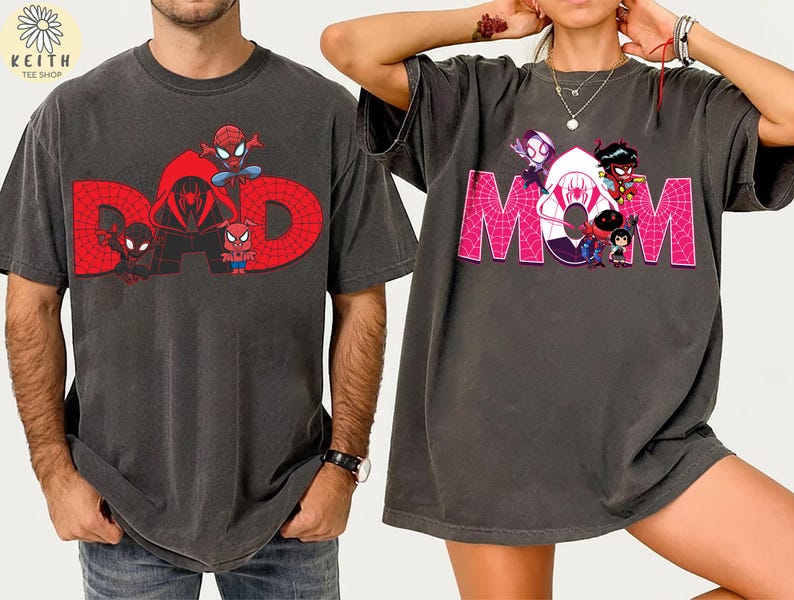 May include: Two dark gray t-shirts. One features the word "DAD" in red with Spider-Man characters. The other shirt has the word "MOM" in pink with Spider-Verse characters. Both shirts are oversized and have short sleeves.
