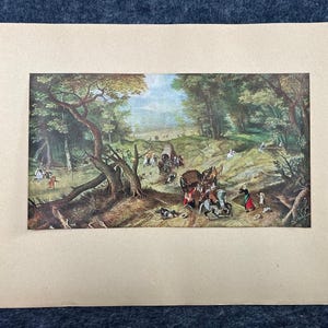May include: A framed print of a historical landscape scene. The artwork depicts a forest with figures, horses, and wagons. The color palette includes greens, browns, and blues, creating a vintage aesthetic. The print is set against a beige background.