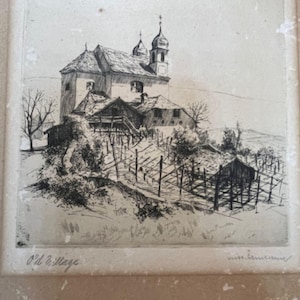 May include: Black and white etching of a village scene. The artwork depicts a church with two bell towers, surrounded by other buildings and a wooden fence. The text "Old Village" is visible at the bottom.