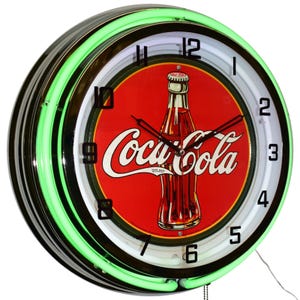 May include: A round wall clock featuring a bright green neon light ring and a chrome finish. The clock face displays a red circular background with a classic glass Coca-Cola bottle illustration and the white Coca-Cola logo in the center.