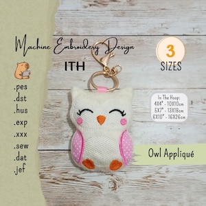 May include: A white owl appliqué keychain with pink polka-dot wings and an orange beak. The keychain has a gold-colored clasp and ring. Text on the image includes "Machine Embroidery Design", "ITH", "3 SIZES", and "Owl Appliqué".