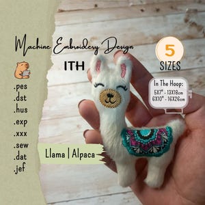 May include: A white llama or alpaca machine embroidery design. The design includes a smiling face, pink ears, and a colorful blanket. The text reads "Machine Embroidery Design ITH" and "Llama | Alpaca". The design is available in 5 sizes, including 5x7" - 13x18cm and 6x10" - 16x26cm.