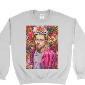 May include: A white sweatshirt with a colorful print of a person wearing sunglasses and a pink jacket. The background of the print is a floral pattern.