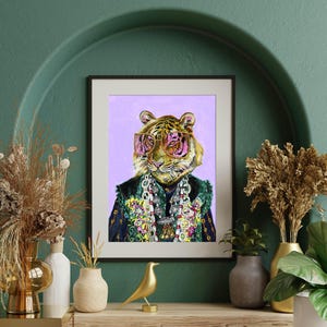 May include: A digital painting of a tiger wearing pink sunglasses and a colorful beaded necklace. The tiger is wearing a blue and green patterned jacket. The background is a light purple color.