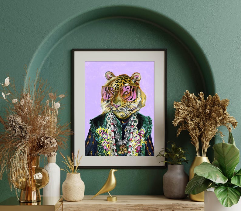 May include: A digital painting of a tiger wearing pink sunglasses and a colorful beaded necklace. The tiger is wearing a blue and green patterned jacket. The background is a light purple color.