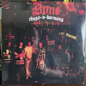 May include: Album cover for Bone Thugs-n-Harmony's "E. 1999 Eternal." The album art features the band members in front of a dark, urban backdrop. The album title and track names are in a stylized font. The cover has a dark, moody aesthetic.