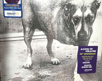 May include: A vinyl record album cover featuring a black and white photograph of a dog with yellow eyes. The cover includes a blue sticker stating Exclusive Purple/White Mix Vinyl and a purple sticker for Alice in Chains 30th Anniversary.