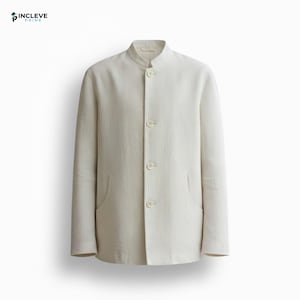 May include: A light beige linen jacket with a mandarin collar and three buttons. The jacket has two front pockets and long sleeves. The garment is displayed on a white background.
