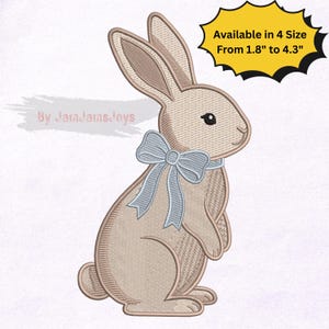 May include: A tan-colored embroidered bunny with a light blue bow tie. The bunny has detailed stitching and is available in four sizes, ranging from 1.8 inches to 4.3 inches. The design is suitable for various craft projects.