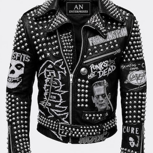 May include: Black leather jacket with silver studs and spikes. Features patches with the words "Misfits", "Frankenstein", "Punks Not Dead", "Haunting the Chapel", and "The Cure". Includes a belt with "AC/DC" buckle.